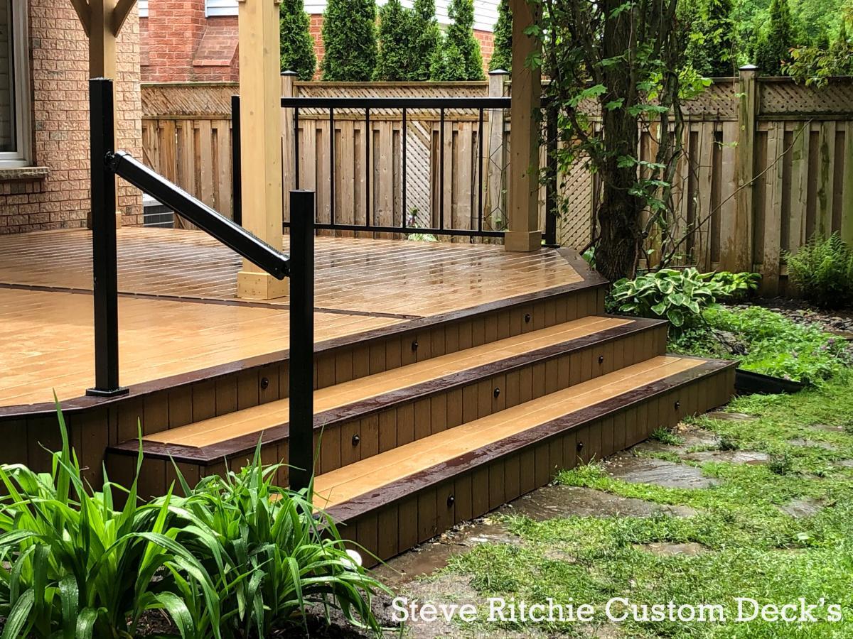 Decking, wide garden steps and dark railing details